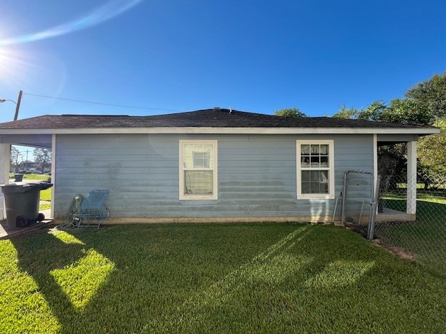 view of side of home with a lawn