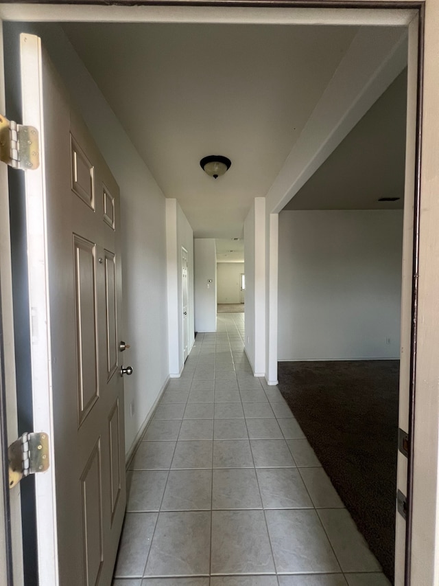 hall featuring light tile patterned floors