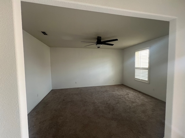 carpeted empty room with ceiling fan