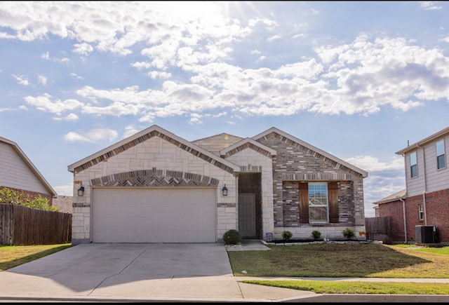 view of front of house with a garage, central air condition unit, and a front yard