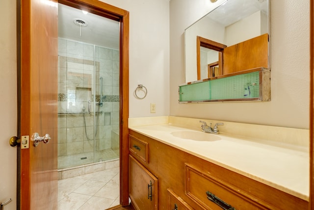 bathroom with vanity, tile patterned flooring, and an enclosed shower