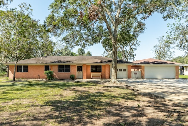 ranch-style home with a front lawn and a garage