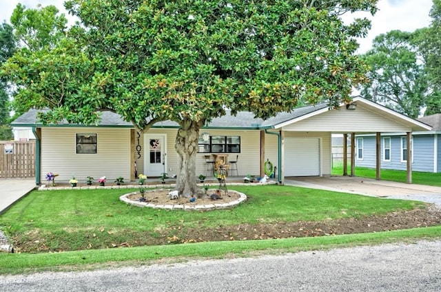 ranch-style house with a carport, a front yard, and a garage