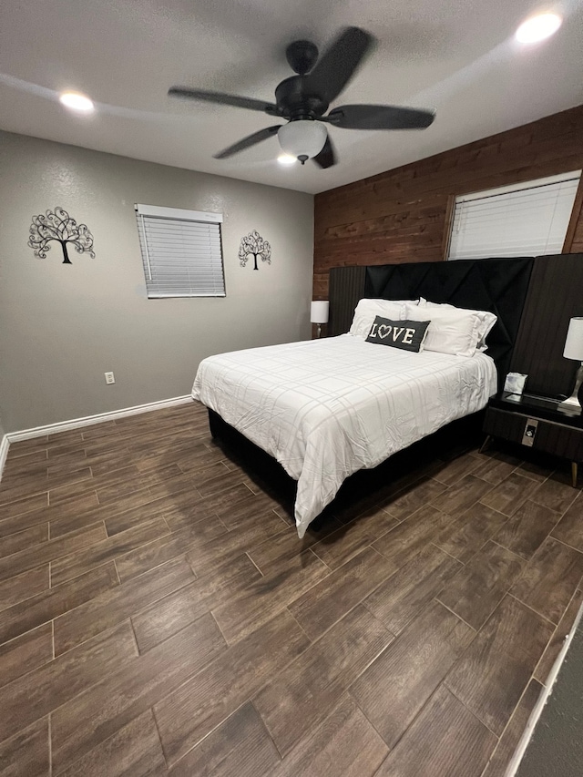 bedroom featuring dark hardwood / wood-style flooring, a textured ceiling, and ceiling fan