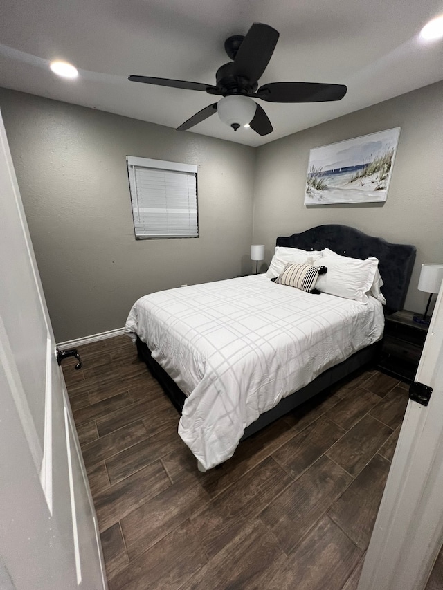 bedroom with ceiling fan and dark hardwood / wood-style floors