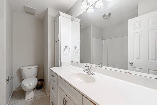 bathroom with tile patterned flooring, vanity, and toilet