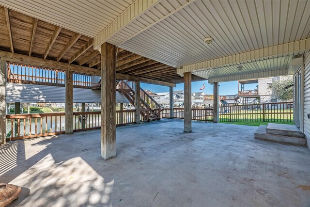 view of patio with a water view and a carport