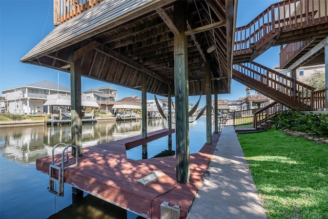 view of dock featuring a water view and a lawn