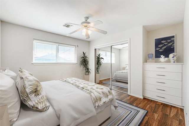 bedroom featuring dark hardwood / wood-style floors, a closet, and ceiling fan