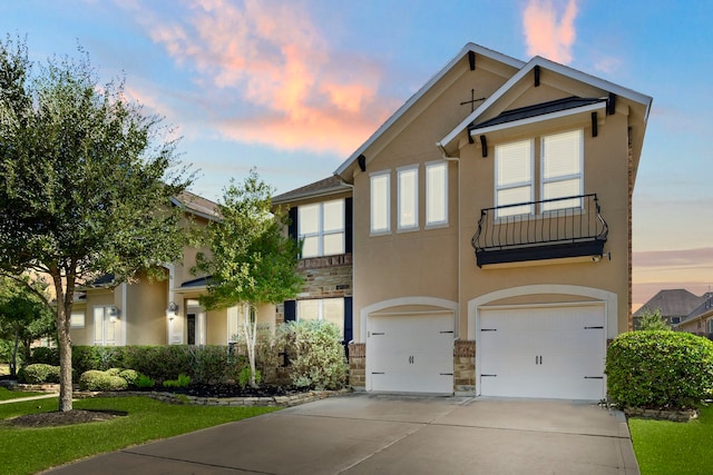 view of front of home with a yard and a garage