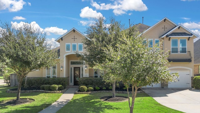 view of front of home featuring a garage and a front lawn