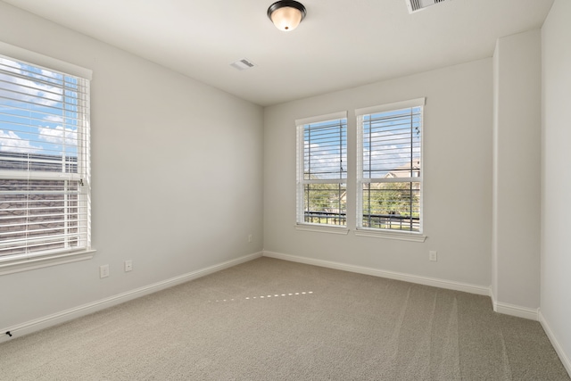 carpeted empty room with plenty of natural light