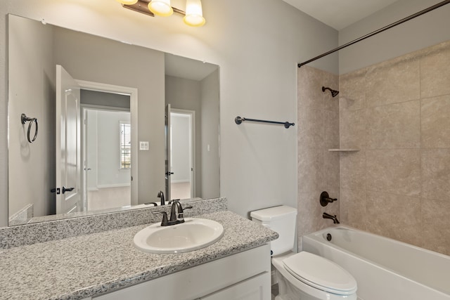 full bathroom with toilet, tiled shower / bath combo, and vanity