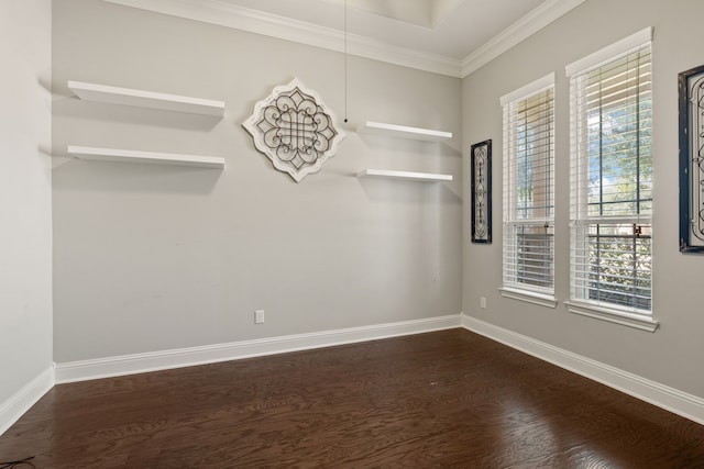 empty room with ornamental molding and dark hardwood / wood-style flooring