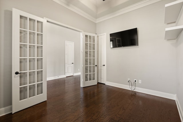 spare room with ornamental molding, french doors, dark hardwood / wood-style floors, and a high ceiling