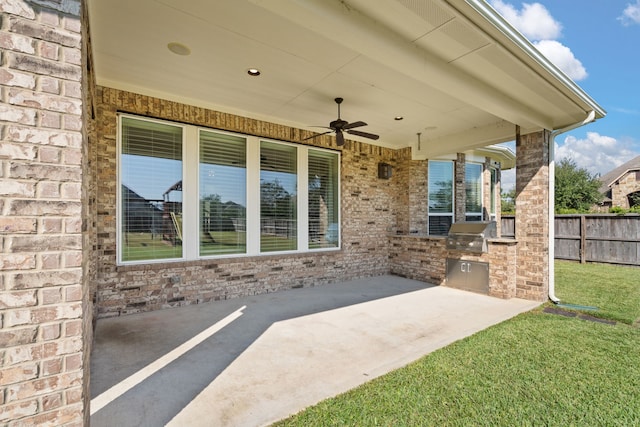 view of patio / terrace featuring ceiling fan, grilling area, and exterior kitchen