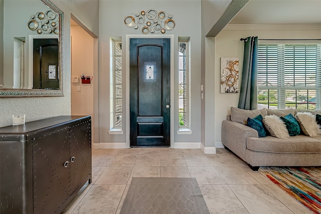 tiled foyer entrance with ornamental molding