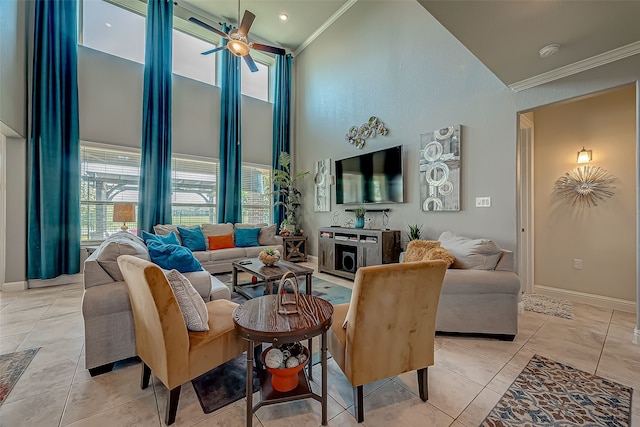 tiled living room featuring a towering ceiling, crown molding, and ceiling fan