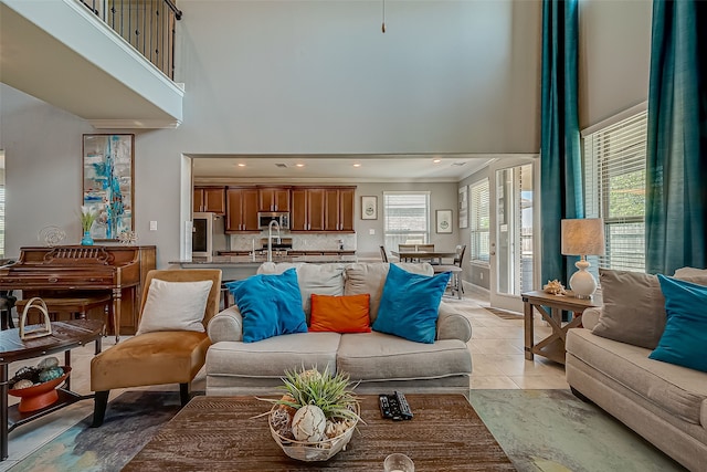 living room with light tile patterned flooring and a towering ceiling