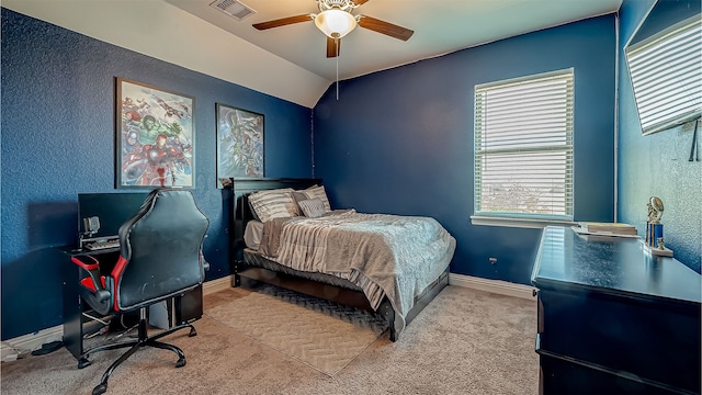 bedroom with ceiling fan, light colored carpet, and lofted ceiling