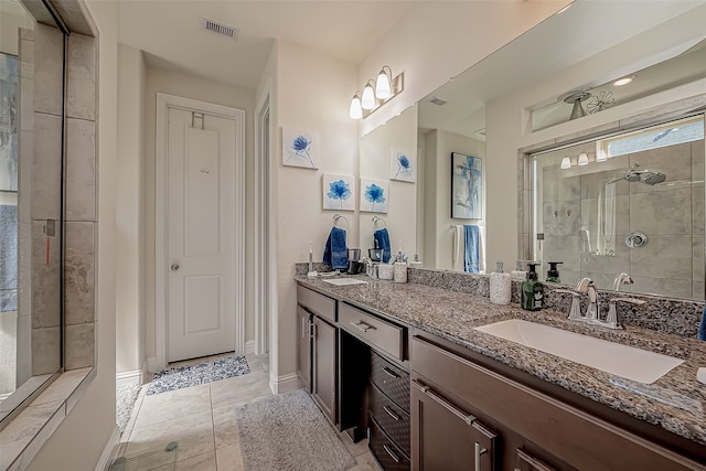 bathroom featuring tile patterned flooring, vanity, and a shower with shower door