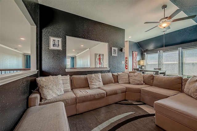 living room featuring hardwood / wood-style flooring, ceiling fan, vaulted ceiling, and a textured ceiling