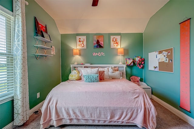 bedroom with ceiling fan, lofted ceiling, and carpet