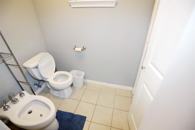 bathroom featuring tile patterned floors, a bidet, toilet, and sink