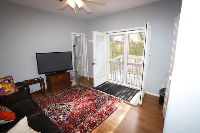 living room with ceiling fan and hardwood / wood-style flooring