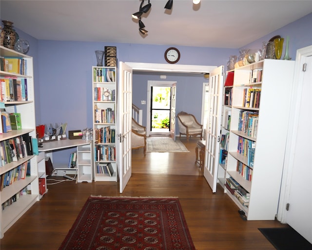 interior space with rail lighting and dark hardwood / wood-style floors