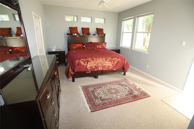 bedroom with ceiling fan and light colored carpet