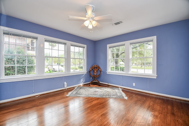 unfurnished room with dark wood-type flooring and ceiling fan