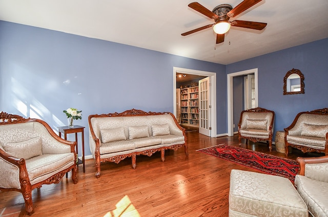 living room with ceiling fan and hardwood / wood-style floors