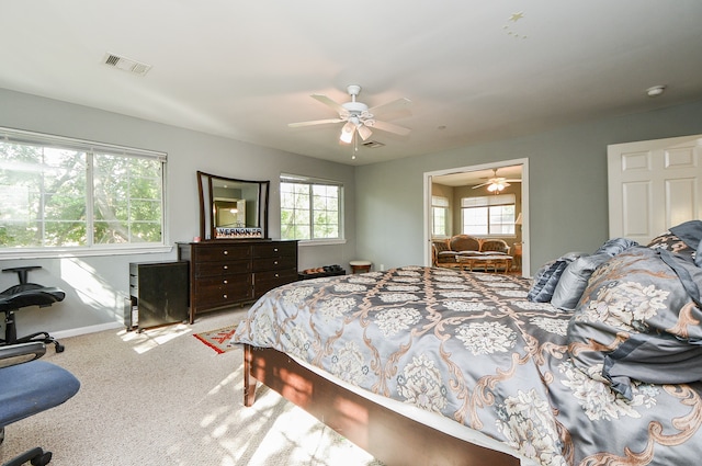 bedroom with ceiling fan and light colored carpet