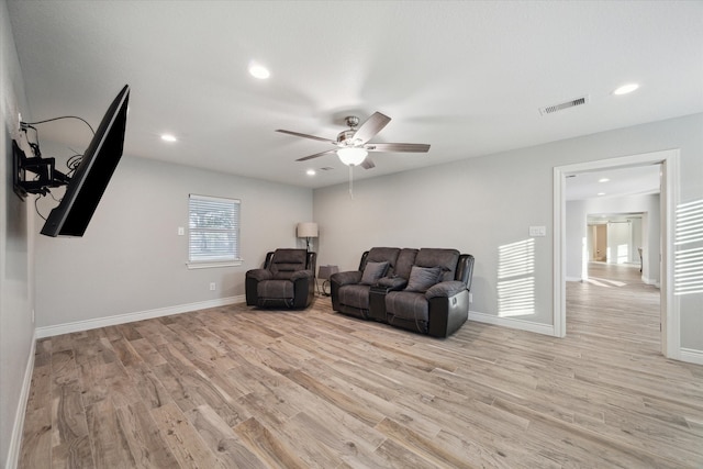 living area with ceiling fan and light hardwood / wood-style floors