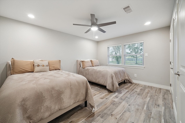 bedroom with ceiling fan and light hardwood / wood-style flooring