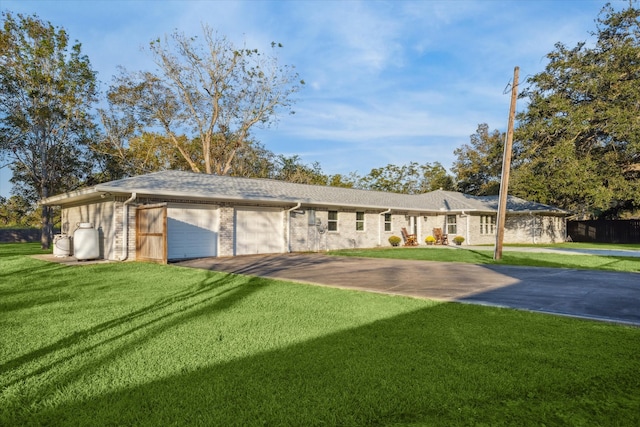 ranch-style house featuring a garage and a front yard