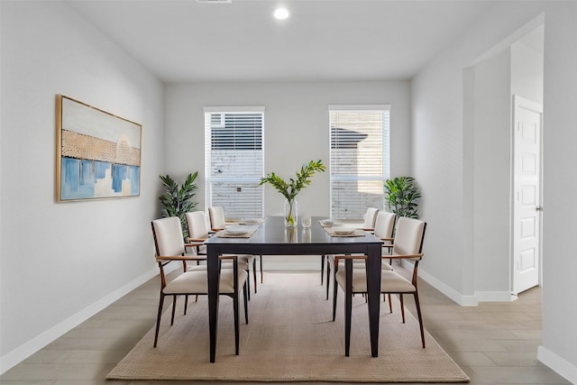 dining space featuring a healthy amount of sunlight and light hardwood / wood-style flooring