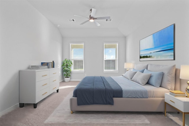 bedroom featuring ceiling fan, vaulted ceiling, and light carpet