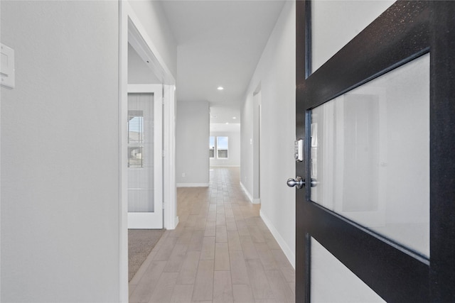 hall with light hardwood / wood-style flooring