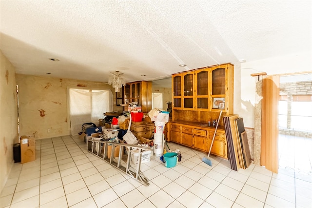 miscellaneous room with light tile patterned flooring and a textured ceiling