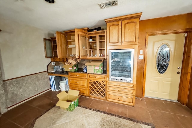 kitchen with dark stone countertops and tile patterned floors