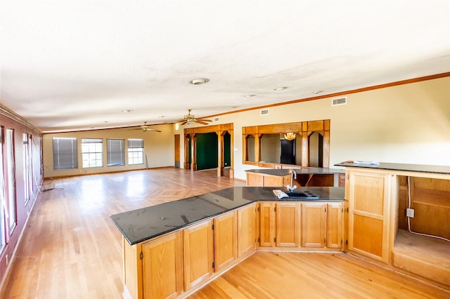 kitchen featuring ceiling fan, crown molding, and light hardwood / wood-style floors