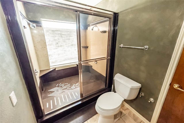 bathroom with a shower with shower door, toilet, and tile patterned flooring