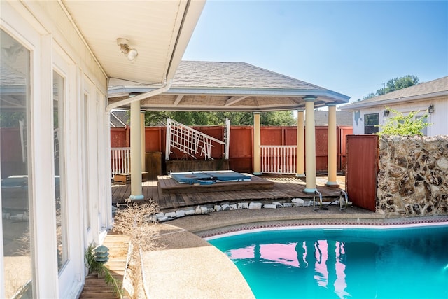 view of pool with a gazebo and a wooden deck