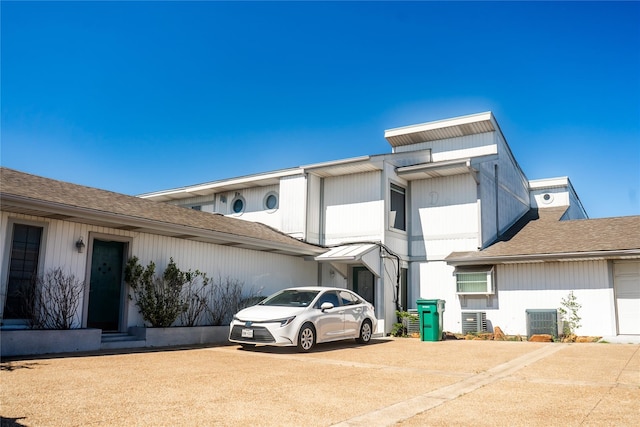 exterior space featuring central AC unit and a garage