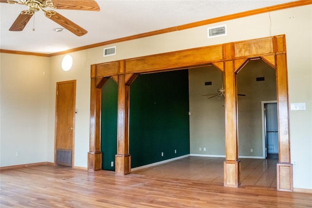 empty room with ornamental molding, ceiling fan, and light hardwood / wood-style floors