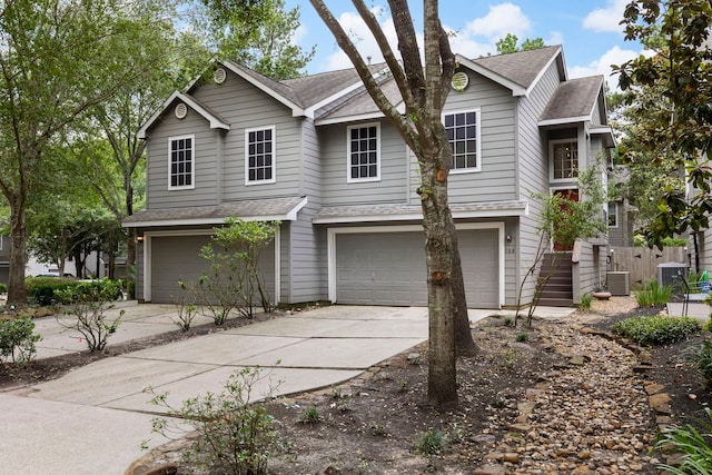 view of front of home featuring a garage and cooling unit