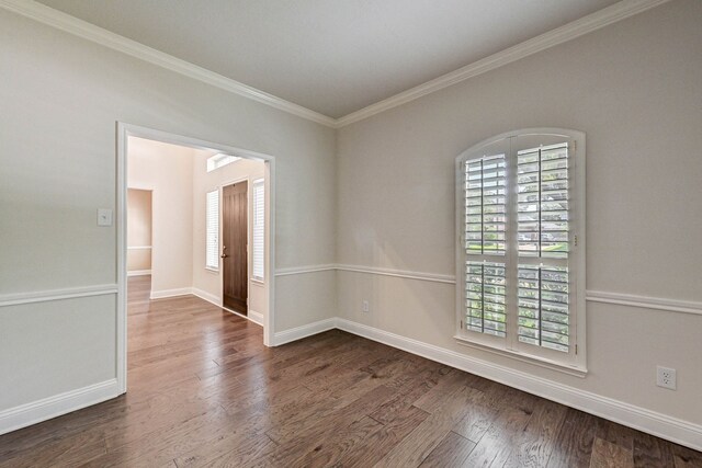 unfurnished room with crown molding and dark hardwood / wood-style flooring