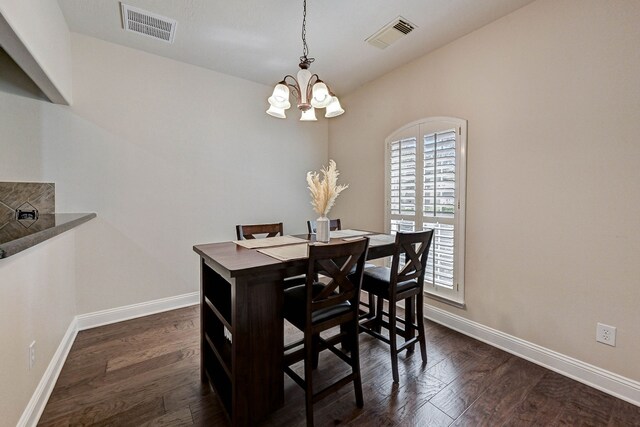 dining room featuring dark wood-type flooring and an inviting chandelier